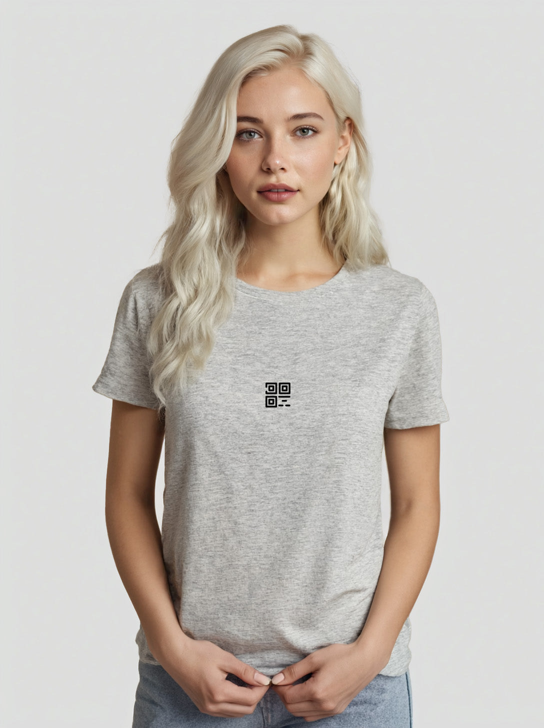 Woman wearing a heather grey t-shirt with the Cue R logo on the front.