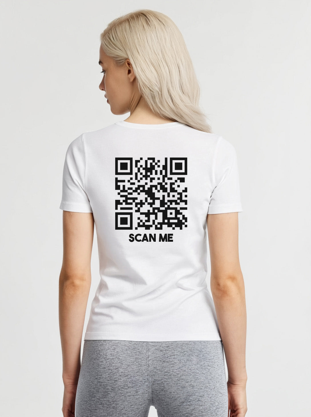 Women wearing a white t-shirt from Cue R with a black QR code and 'SCAN ME' text on the back.