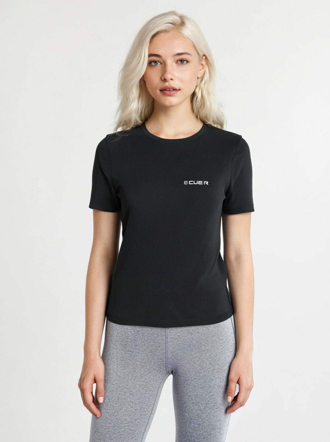 Woman wearing a black t-shirt with the Cue R logo on the front.