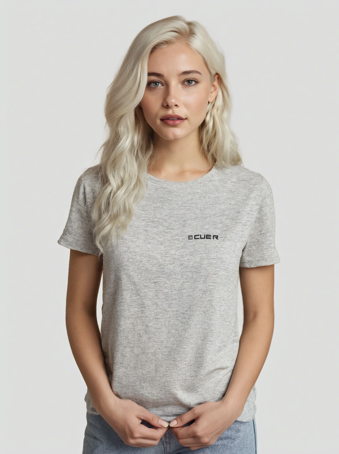 Woman wearing a heather grey t-shirt with the Cue R logo on the front.