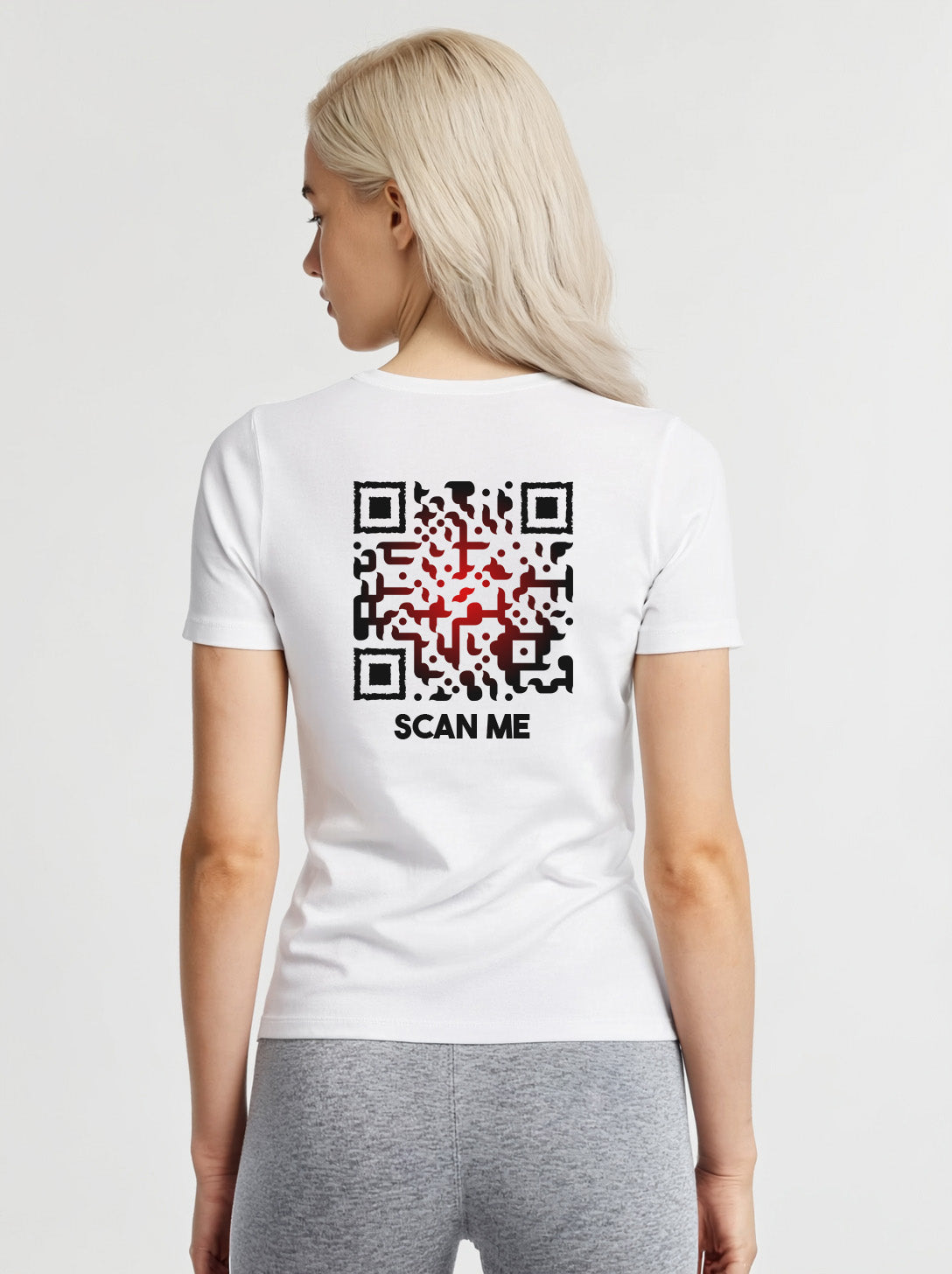 Women wearing a white t-shirt from Cue R with a black-red QR code and 'SCAN ME' text on the back.